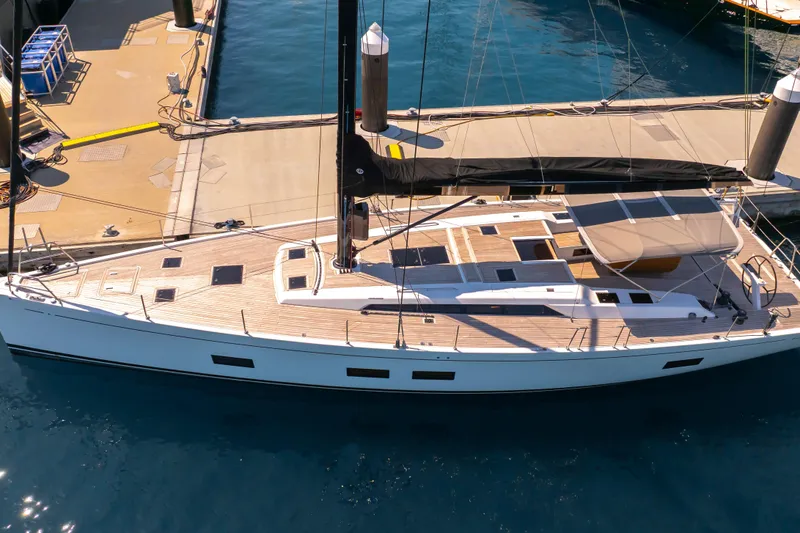 Slide: The Image of Grand Soleil 58 yacht, 2016 model, docked at marina with sleek design and wooden deck. - 7