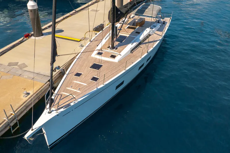 Slide: The Image of Grand Soleil 58 yacht, 2016 model, docked at marina with sleek design and wooden deck. - 8