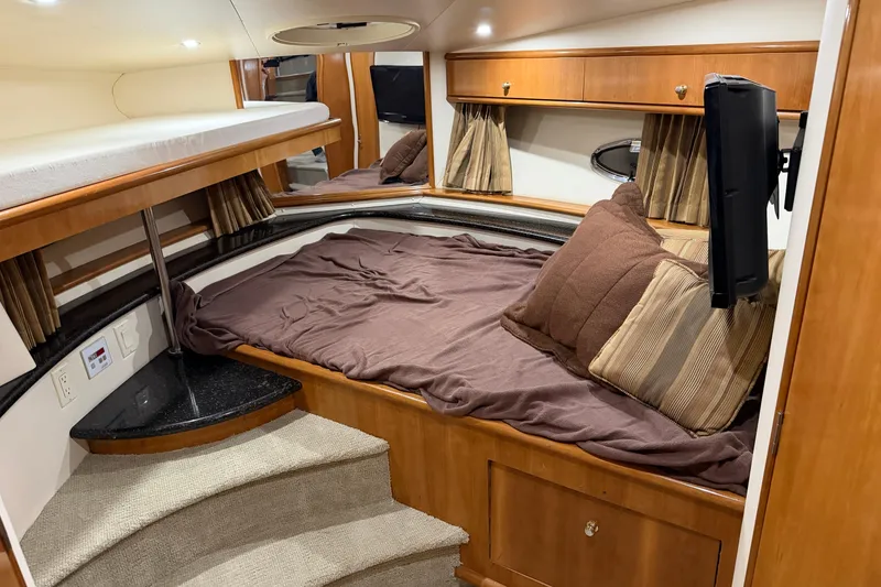 Slide: The Image of Interior of 2001 Carver 444 Cockpit Motor Yacht with cozy bed and TV. - 12