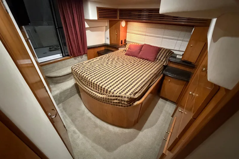 Slide: The Image of Luxurious bedroom interior of 2001 Carver 444 Cockpit Motor Yacht with cozy bedding. - 26