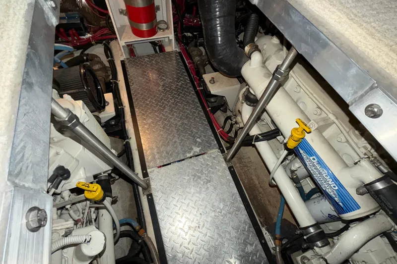 Slide: The Image of Engine room of 2001 Carver 444 Cockpit Motor Yacht with visible machinery and components. - 36