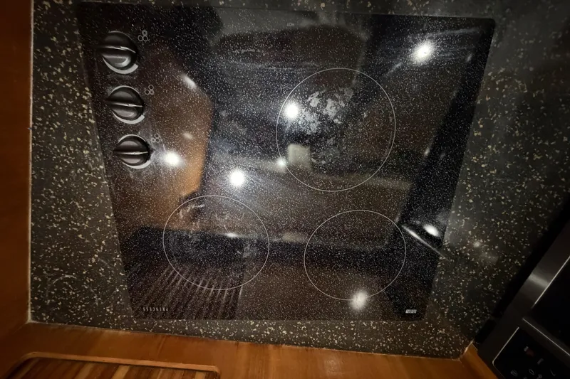 Slide: The Image of Glass cooktop with three burners on a 2001 Carver 444 Cockpit Motor Yacht. - 8