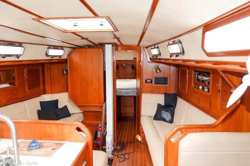 Slide: The Image of Interior of a 1987 Sabre 42 sailboat with wooden finishes and cozy seating. - 11
