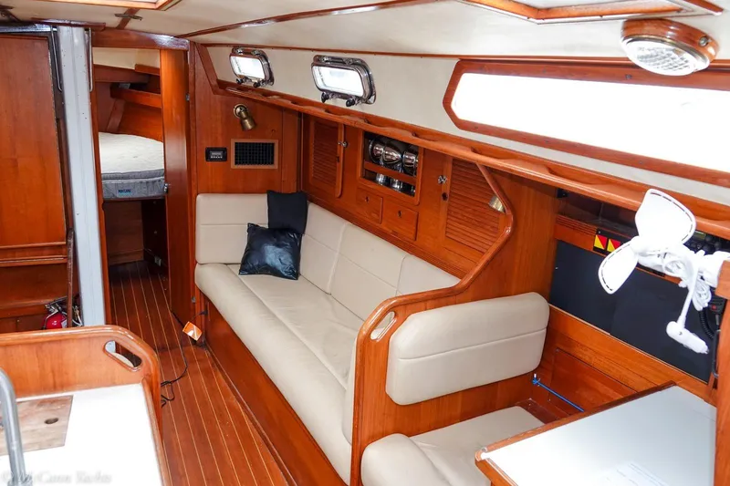 Slide: The Image of Interior of 1987 Sabre 42 sailboat with wooden finish and beige seating. - 13