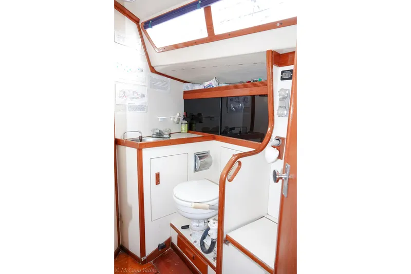 Slide: The Image of 1987 Sabre 42 yacht bathroom with wooden trim and compact design. - 16