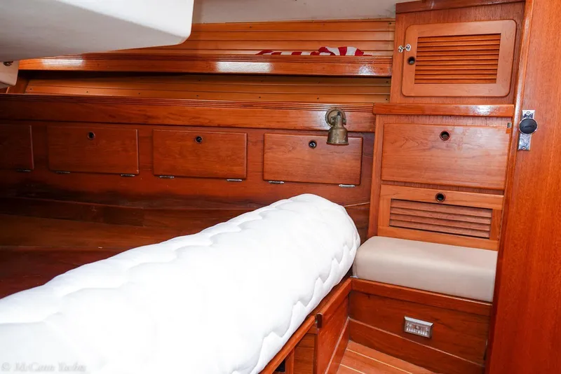 Slide: The Image of Interior of 1987 Sabre 42 yacht with wooden cabinetry and cushioned seating. - 17