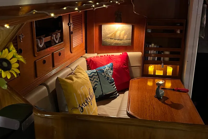 Slide: The Image of Cozy interior of 1987 Sabre 42 sailboat with cushions, candles, and nautical decor. - 20