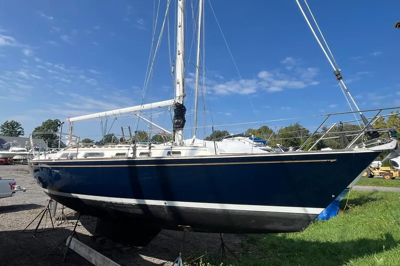 Slide: The Image of 1987 Sabre 42 sailboat on land under clear blue sky. - 21