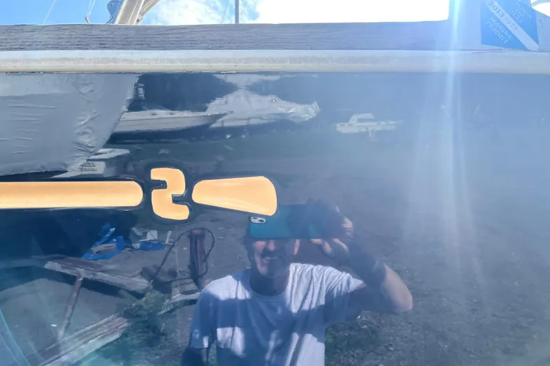 Slide: The Image of Reflection on a 1987 Sabre 42 boat hull with a person taking a photo. - 27