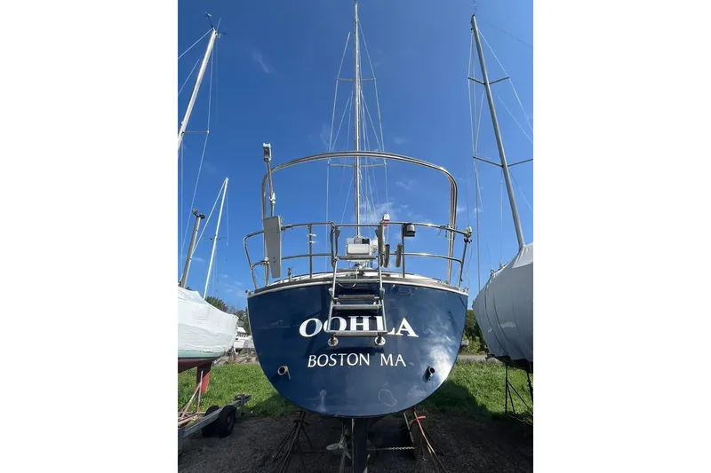 Slide: The Image of 1987 Sabre 42 sailboat on land, blue hull, clear sky background. - 28