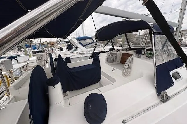 Slide: The Image of 2002 Catalina 400 MkII sailboat cockpit with blue covers in marina setting. - 10