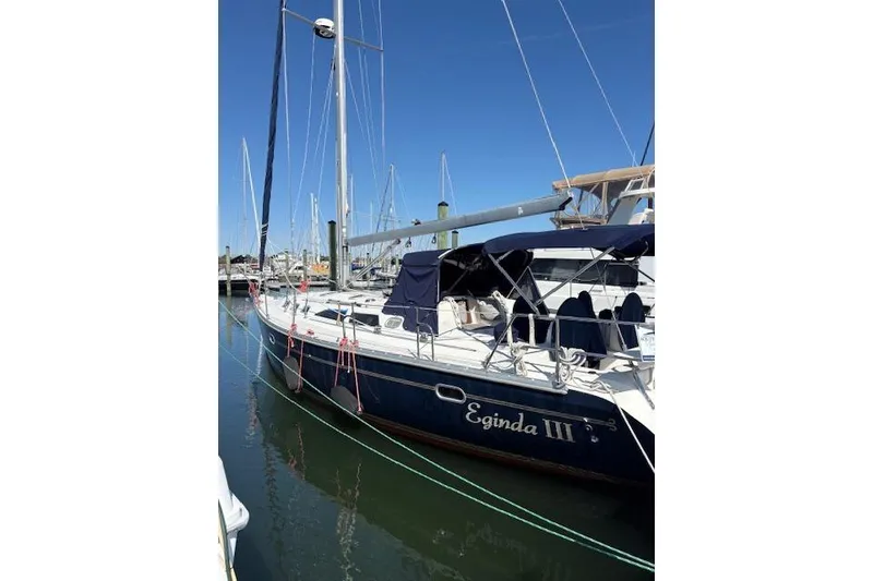 Slide: The Image of Catalina 400 MkII 2002 sailboat docked in marina, blue hull, clear sky. - 11