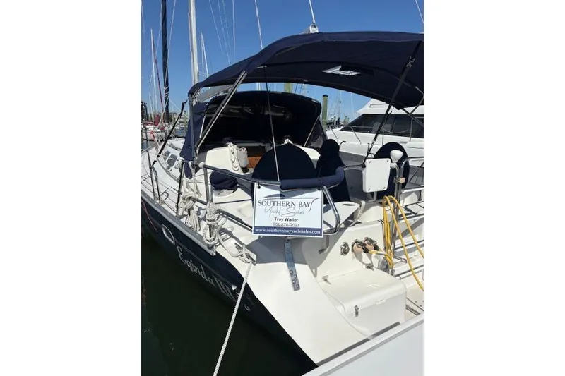 Slide: The Image of 2002 Catalina 400 MkII sailboat docked with navy canopy and Southern Bay Yacht Sales sign. - 12