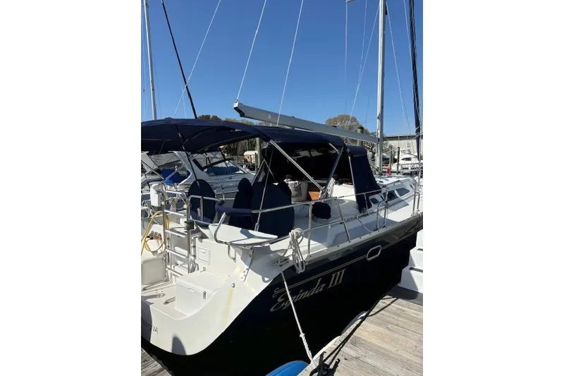 Slide: The Image of 2002 Catalina 400 MkII sailboat docked with blue canopy and sleek design. - 13