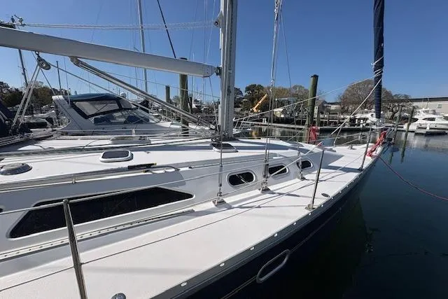 Slide: The Image of 2002 Catalina 400 MkII sailboat docked at marina under clear blue sky. - 15
