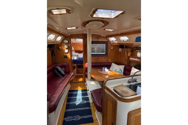 Slide: The Image of Interior of a 2002 Catalina 400 MkII sailboat with cozy seating and wooden finishes. - 25