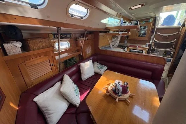 Slide: The Image of Interior of 2002 Catalina 400 MkII sailboat with cozy seating and wooden table. - 27