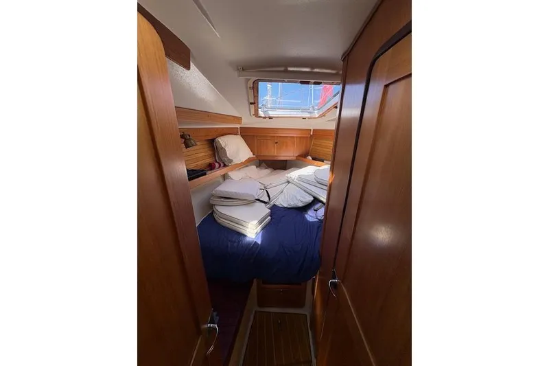 Slide: The Image of Cozy cabin interior of 2002 Catalina 400 MkII sailboat with wooden finish and bedding. - 29