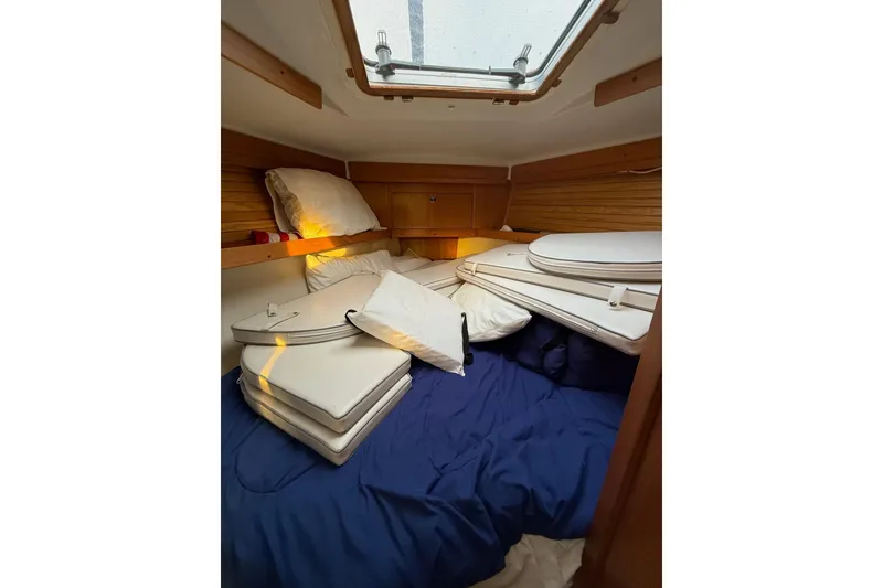 Slide: The Image of Cozy cabin interior of 2002 Catalina 400 MkII sailboat with cushions and bedding. - 3
