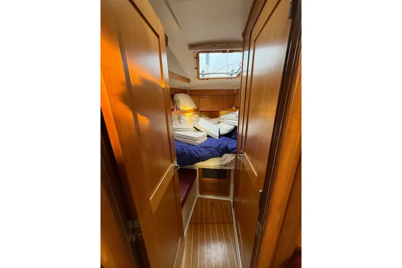Slide: The Image of Cozy cabin interior of 2002 Catalina 400 MkII sailboat with wooden finish and bedding. - 4