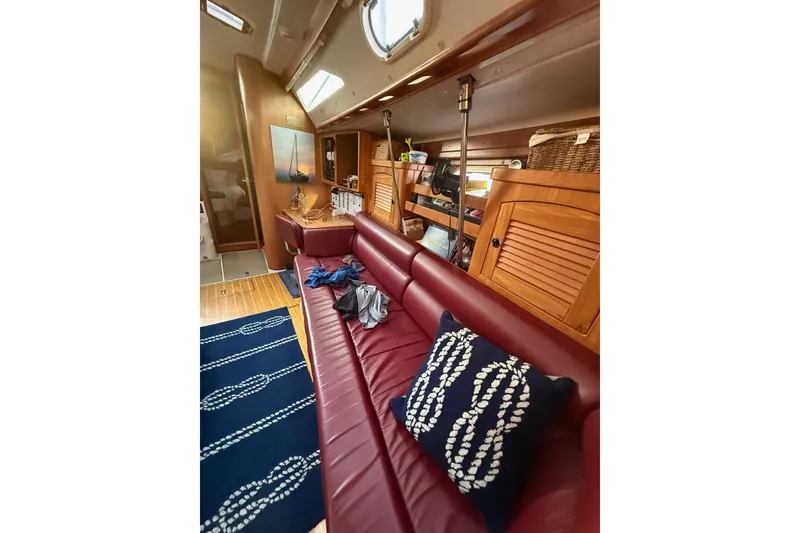 Slide: The Image of Interior of 2002 Catalina 400 MkII sailboat with red leather seating and nautical decor. - 5