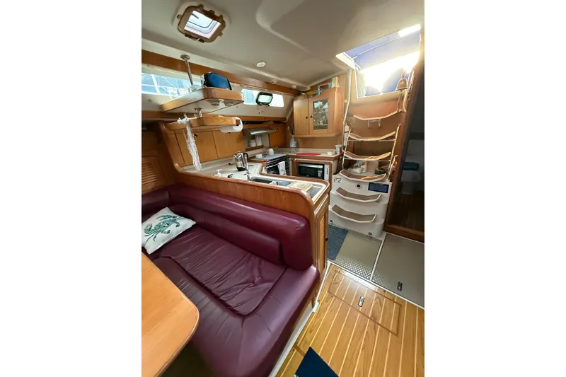 Slide: The Image of Interior of 2002 Catalina 400 MkII sailboat with cozy seating and well-equipped kitchen. - 6