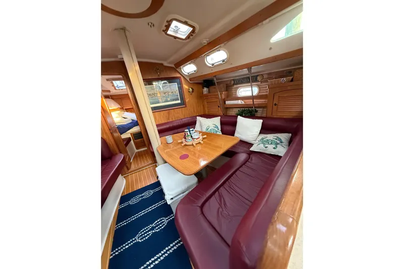 Slide: The Image of Interior of 2002 Catalina 400 MkII sailboat with cozy seating and wooden table. - 7