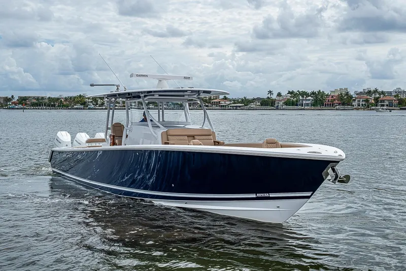 Slide: The Image of 2024 Jupiter 43 boat cruising on a calm waterway under a cloudy sky. - 14