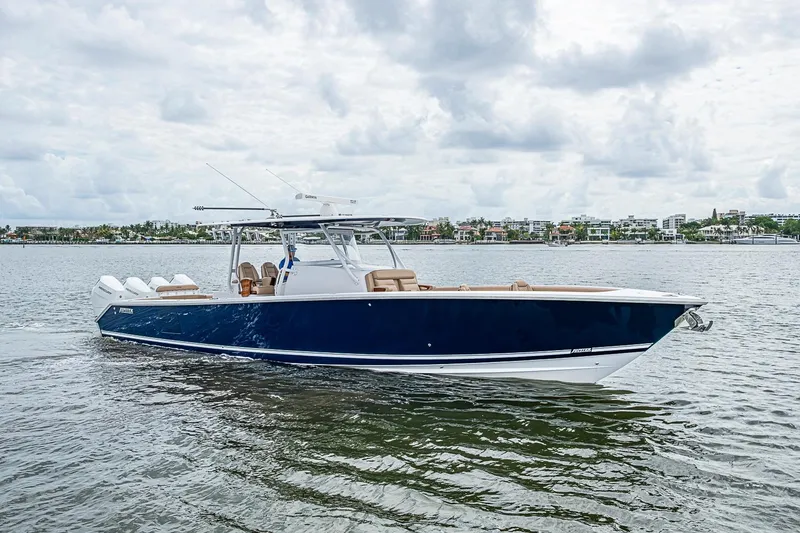 Slide: The Image of 2024 Jupiter 43 boat on calm water under cloudy sky. - 15