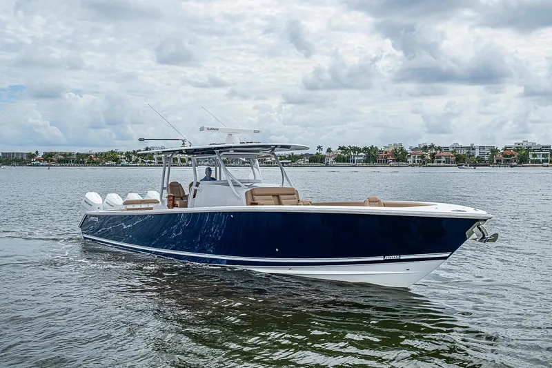 Slide: The Image of 2024 Jupiter 43 boat cruising on a calm waterway under a cloudy sky. - 16