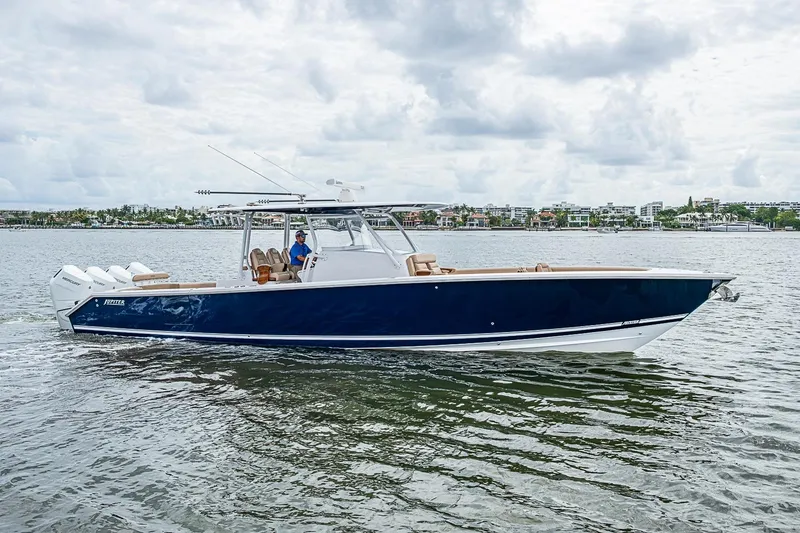 Slide: The Image of 2024 Jupiter 43 boat cruising on a calm waterway under a cloudy sky. - 17