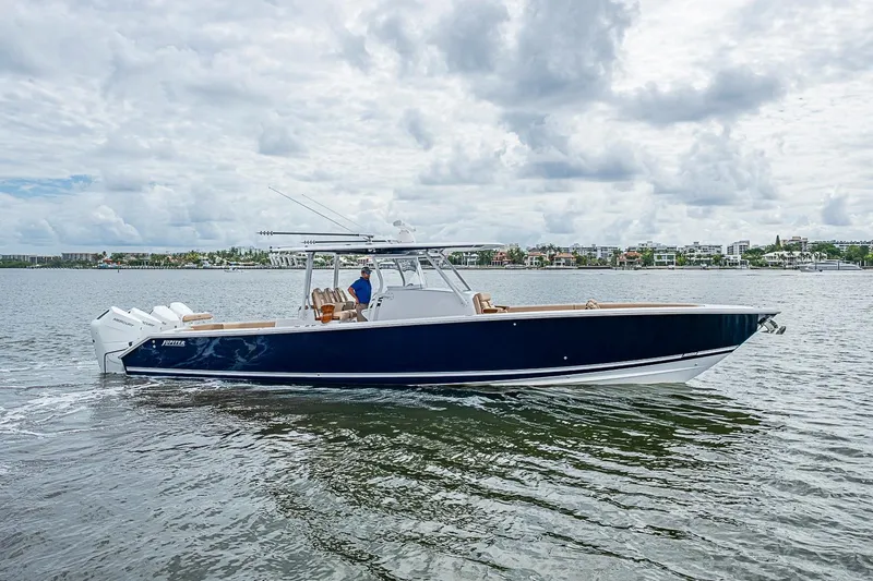Slide: The Image of 2024 Jupiter 43 boat cruising on a calm waterway under a cloudy sky. - 18