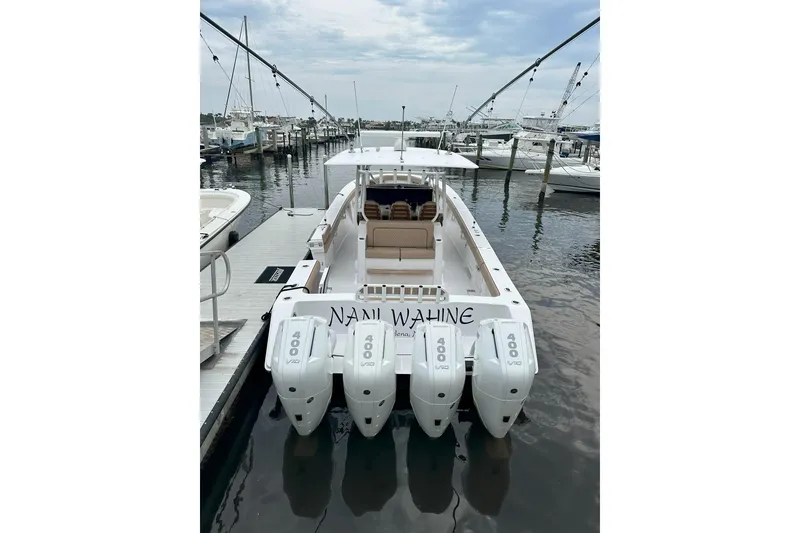 Slide: The Image of 2024 Jupiter 43 boat docked with four powerful outboard engines. - 21