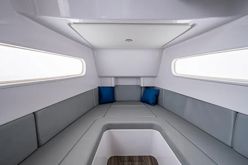 Slide: The Image of Interior of 2024 Jupiter 43 boat with gray seating and blue cushions. - 23