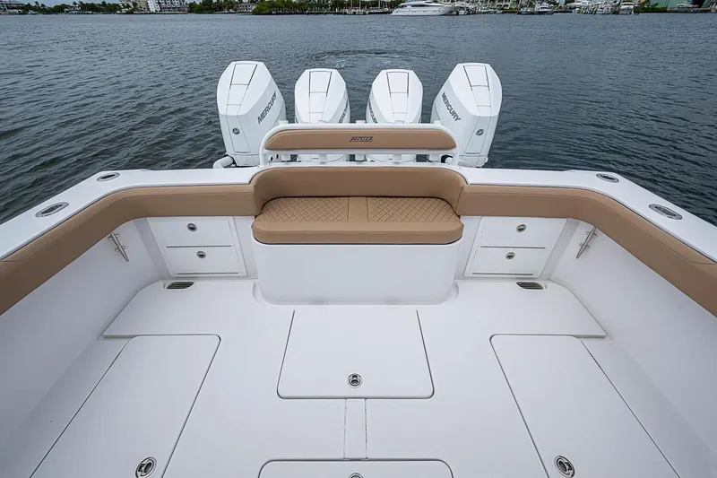 Slide: The Image of 2024 Jupiter 43 boat deck with seating and Mercury engines on water. - 27