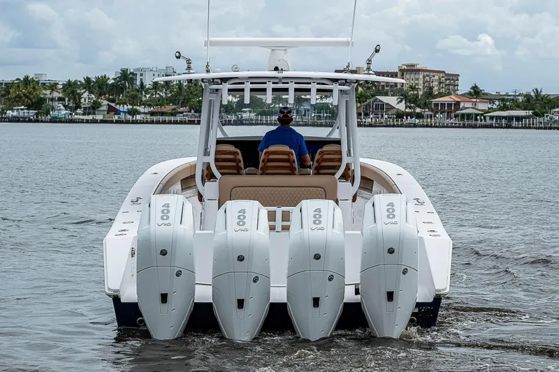 Slide: The Image of 2024 Jupiter 43 boat with quad 400 V10 engines cruising on a calm waterway. - 3