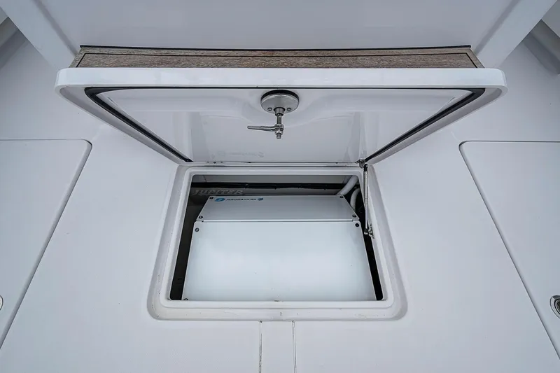 Slide: The Image of Open hatch on 2024 Jupiter 43 boat, revealing interior compartment. - 30