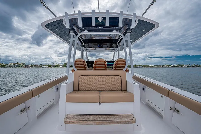Slide: The Image of 2024 Jupiter 43 boat interior with luxurious seating and open water view. - 32