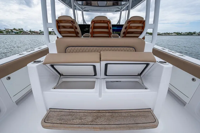 Slide: The Image of 2024 Jupiter 43 boat interior with cushioned seating and storage compartments. - 33