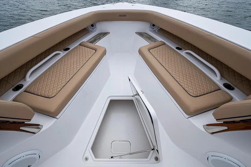 Slide: The Image of Luxurious seating on 2024 Jupiter 43 boat with diamond-stitched cushions and storage compartment. - 36