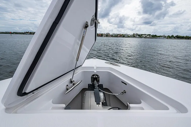 Slide: The Image of Open anchor compartment on 2024 Jupiter 43 boat, with scenic waterfront view. - 37