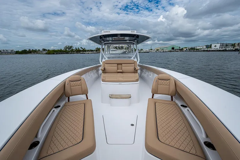 Slide: The Image of 2024 Jupiter 43 boat interior with luxurious tan seating on calm water. - 38