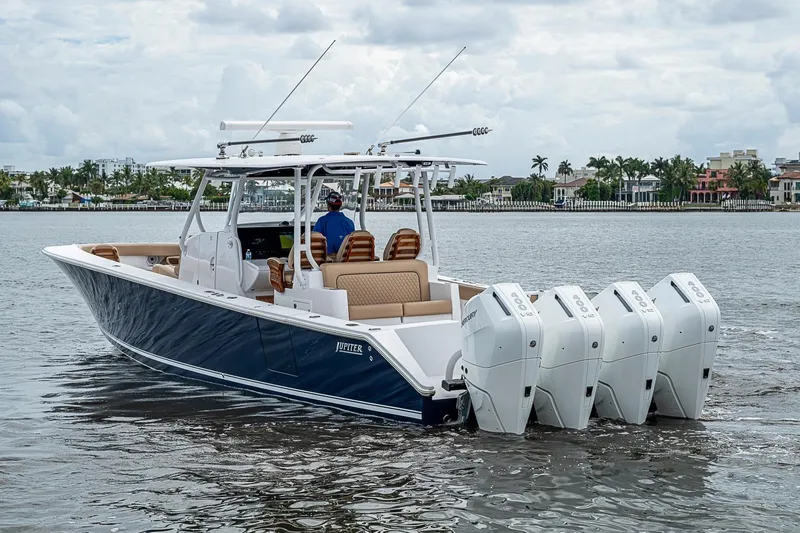 Slide: The Image of 2024 Jupiter 43 boat with four engines cruising on a calm waterway. - 4