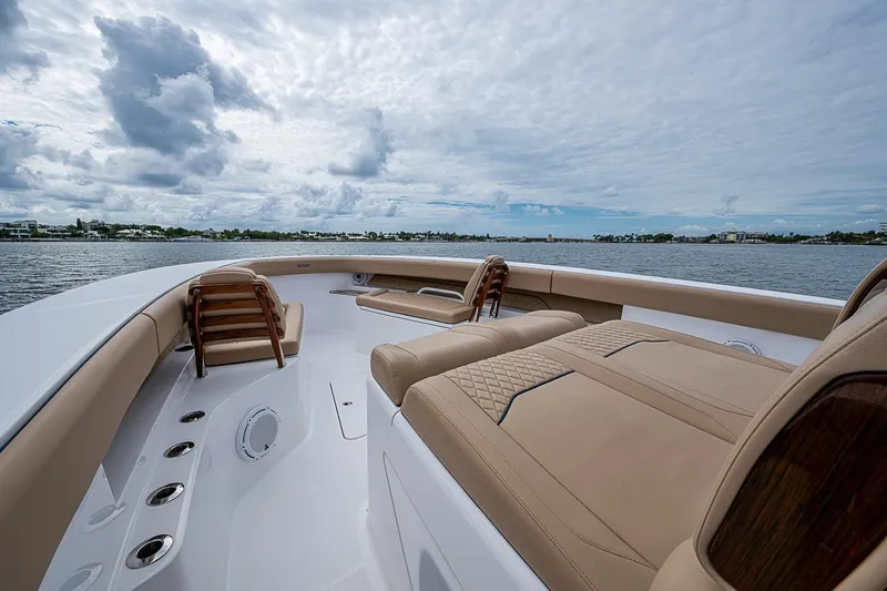 Slide: The Image of Luxurious 2024 Jupiter 43 yacht interior with plush seating, cruising on a serene waterway. - 40