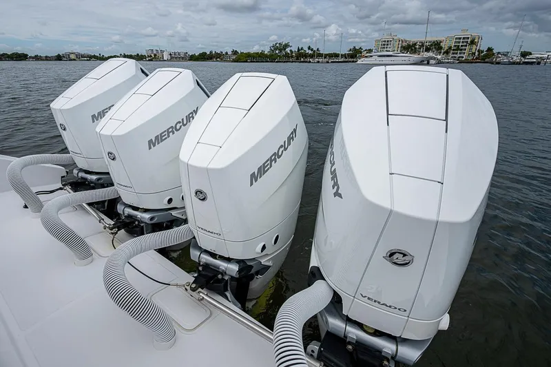 Slide: The Image of Four Mercury outboard engines on a 2024 Jupiter 43 boat, docked by the water. - 41