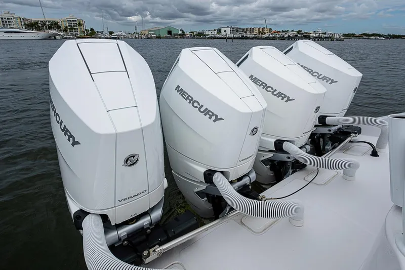 Slide: The Image of Four Mercury Verado outboard engines on a 2024 Jupiter 43 boat, docked by the waterfront. - 42