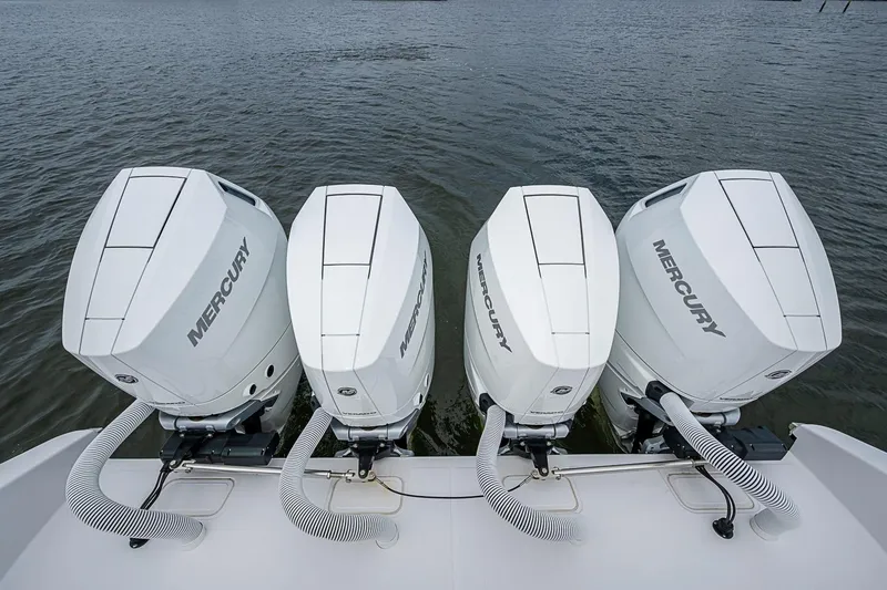Slide: The Image of Four Mercury outboard engines on a 2024 Jupiter 43 boat, docked on water. - 43
