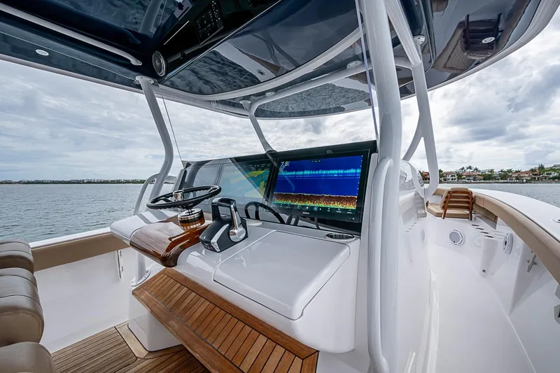 Slide: The Image of 2024 Jupiter 43 boat helm with advanced navigation display and luxurious wood accents. - 45