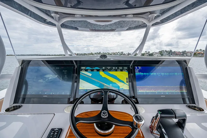 Slide: The Image of Cockpit of 2024 Jupiter 43 boat with advanced navigation displays and steering wheel. - 48