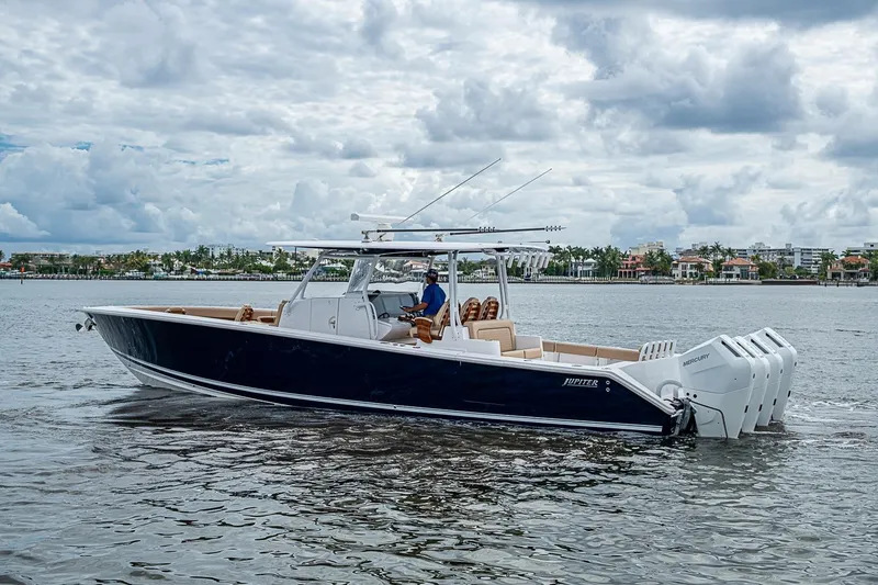 Slide: The Image of 2024 Jupiter 43 boat cruising on water under cloudy sky. - 5